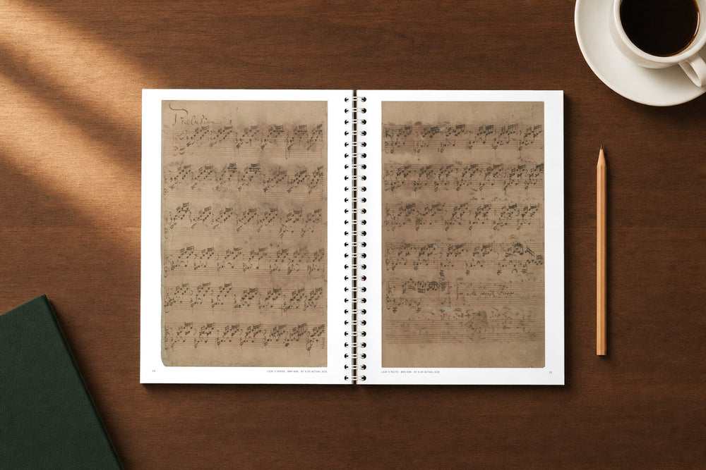 Bach's Well-Tempered Clavier staff-paper notebook on a desk, open at the first prelude in Bach's hand — digitally composed view