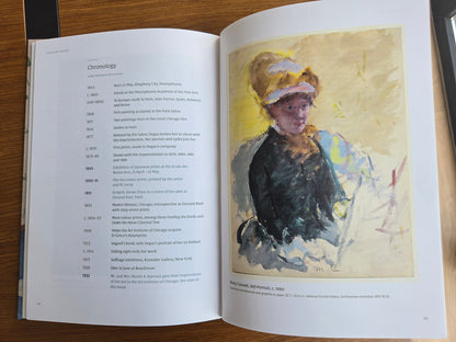 Mary Cassatt — Colour on Copper — the printed book open at the chronology, facing her self-portrait (photograph)