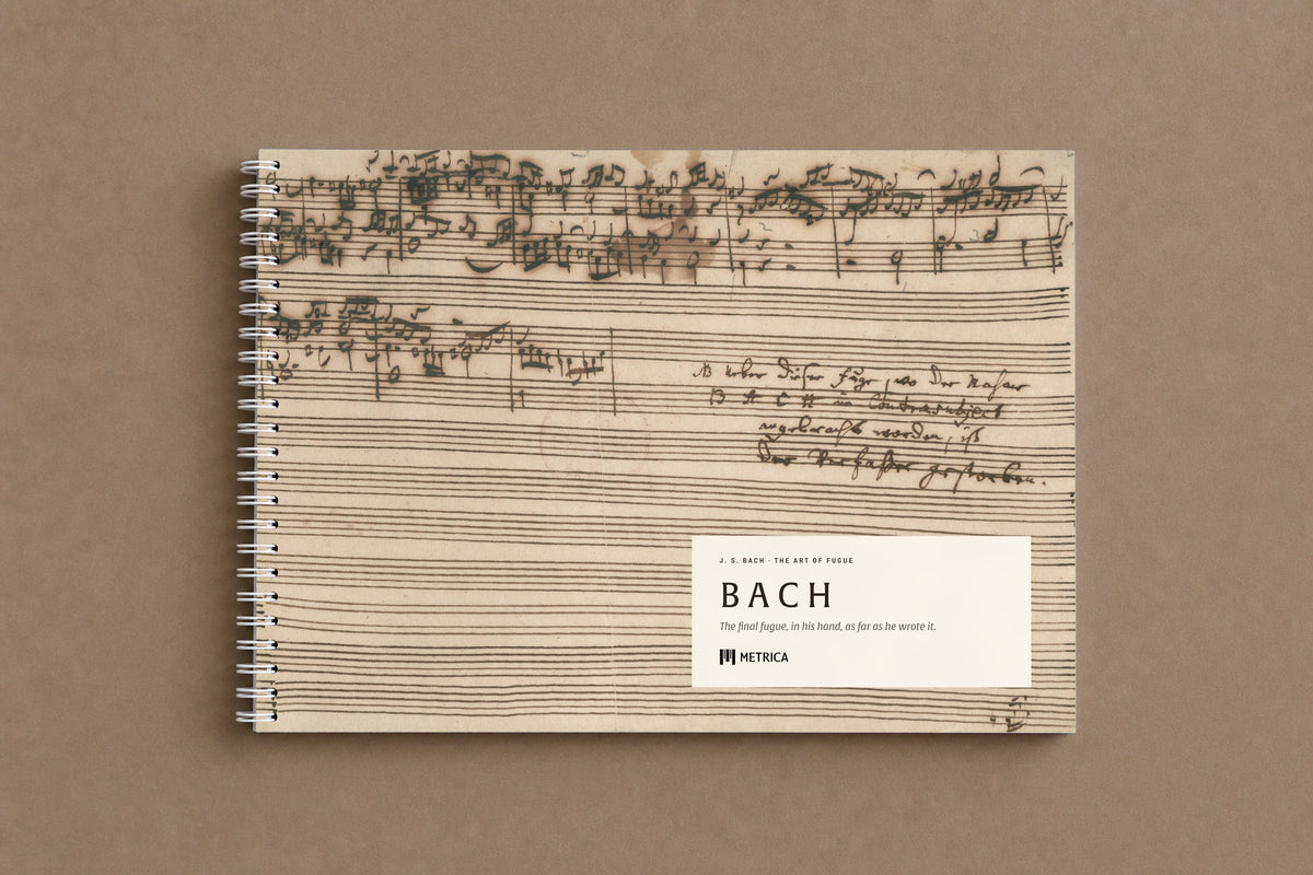 B A C H — the notebook closed: the last page of the fugue on the cover, where the music stops and the note begins, white spiral on the left, digitally composed product view