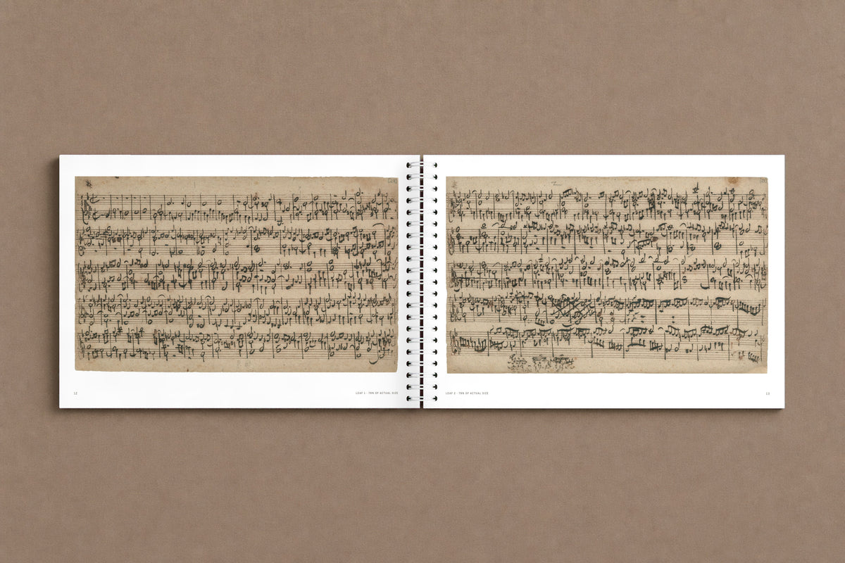 B A C H — open notebook with the first two leaves of the fugue in Bach's hand, digitally composed product view