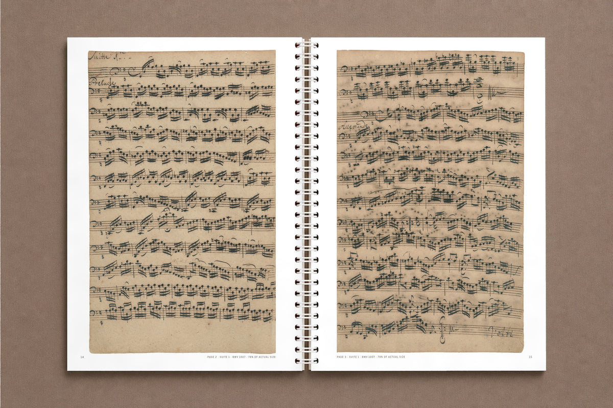 Senza Basso — open notebook with the first pages of Suite 1 in Anna Magdalena Bach's hand, at 78% of actual size, digitally composed product view